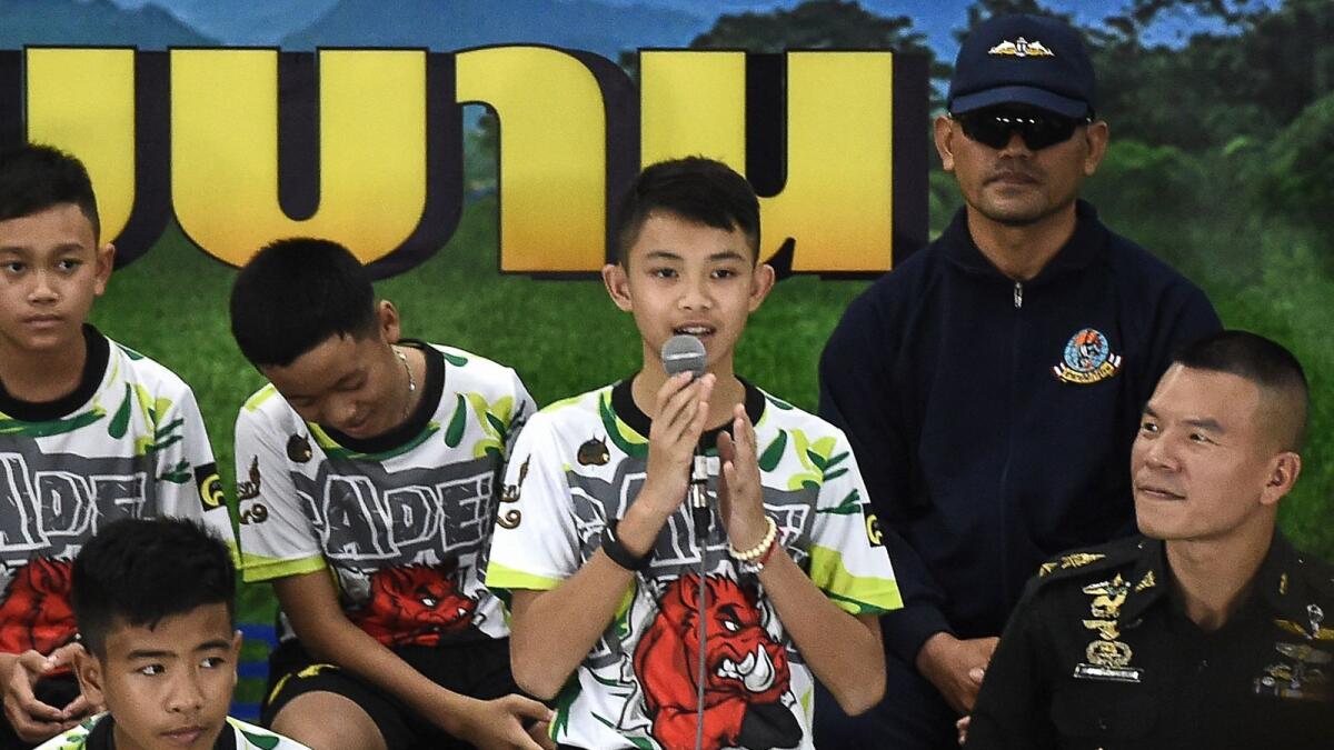 Duangpetch Promthep (centre), one of the 12 boys rescued from deep inside a Thai cave after being trapped for more than a fortnight, speaks during a press conference in Chiang Rai following their discharge from hospital in this July 2018 photo. — AFP file