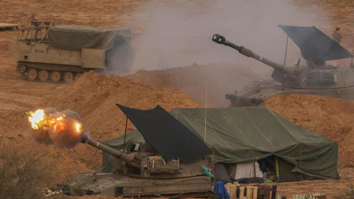An Israeli army self-propelled artillery howitzer fires rounds from a position near the border with the Gaza Strip in southern Israel. — AFP