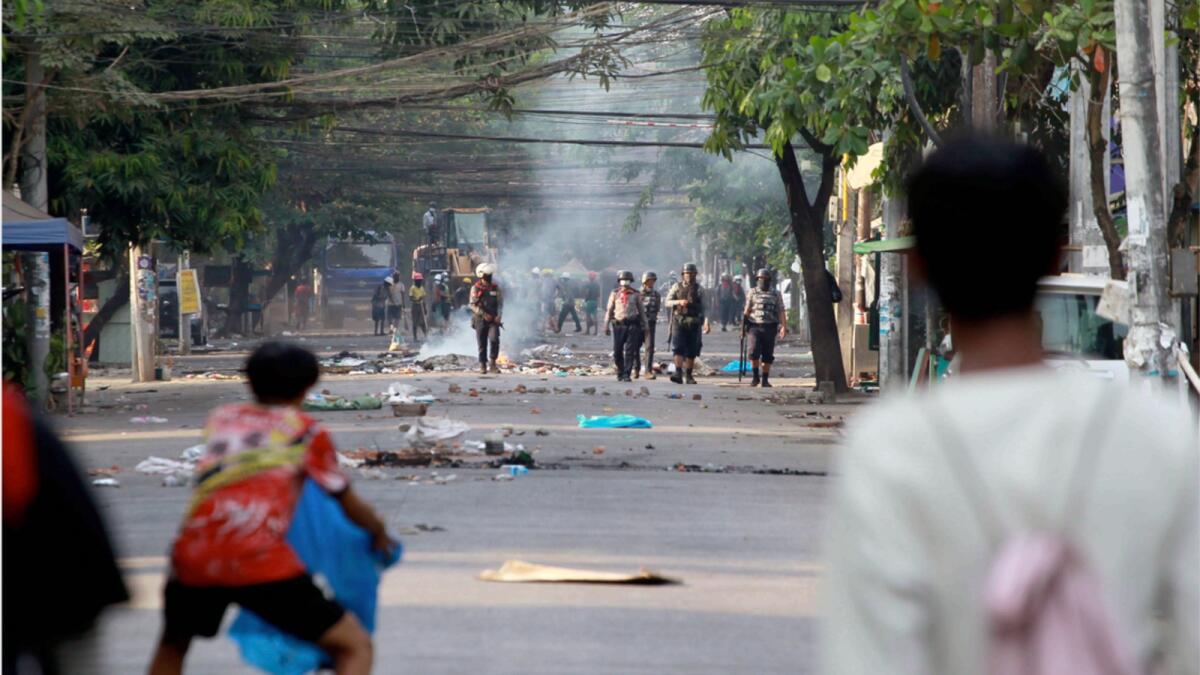 Anti-coup demonstrators prepare to confront police during a protest in Tarmwe township, Yangon. — AP