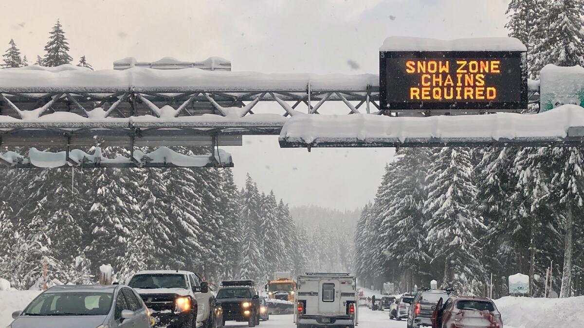 Heavy traffic is seen at the base of a snowy Santiam Pass in Detroit. — AP