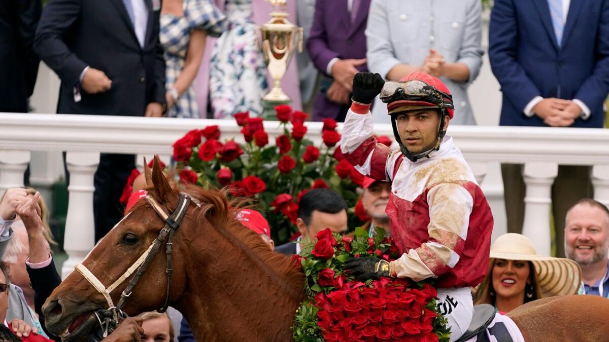 Jockey Sonny Leon celebrates in the winner's circle after Rich Strike's stunning victory in the Kentucky Derby at Churchill Downs on Saturday. (AP)