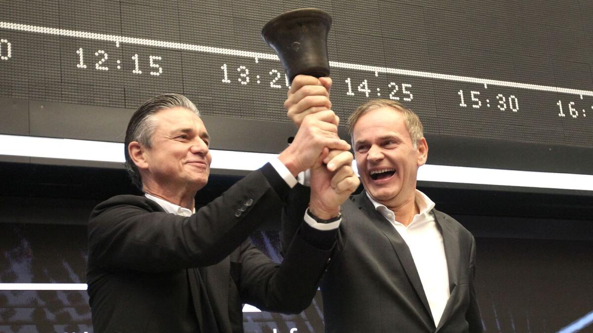 Oliver Blume (right), CEO of German car producer Porsche AG, and Lutz Meschke, member of the Porsche management board, ring the bell to launch the company's initial public offering (IPO) at the Frankfurt Stock Exchange in Frankfurt, on September 29, 2022. Luxury sports carmaker Porsche raced onto the Frankfurt stock exchange with one of Europe's biggest listings in years, leveraging its brand power to defy global market turmoil. — AFP