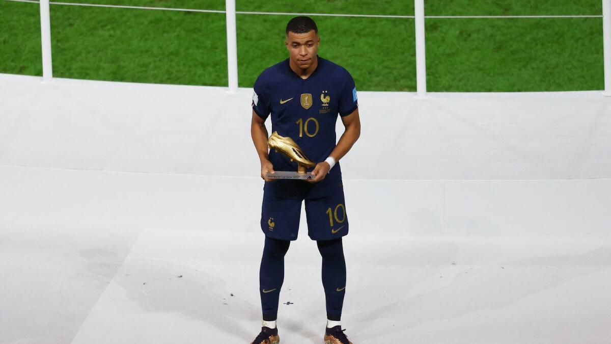 France's Kylian Mbappe poses with the Golden Boot award. Photo: Reuters