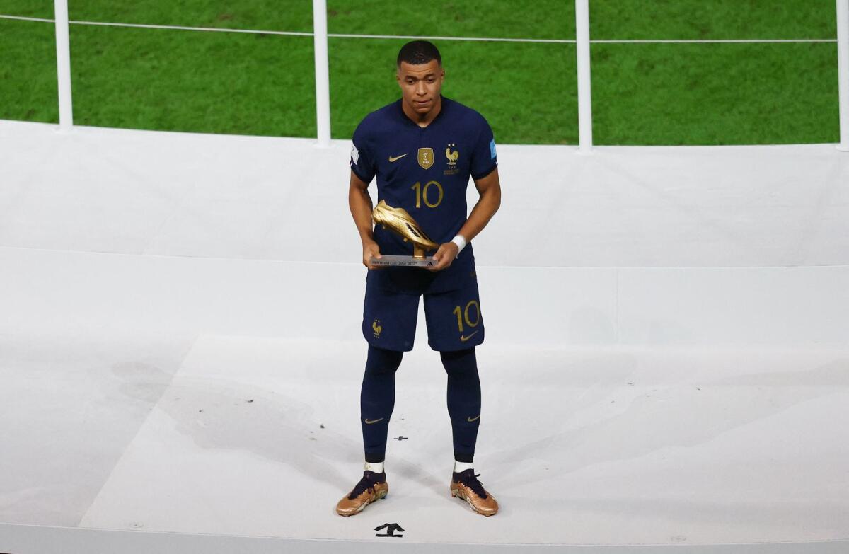 France's Kylian Mbappe poses with the Golden Boot award. Photo: Reuters