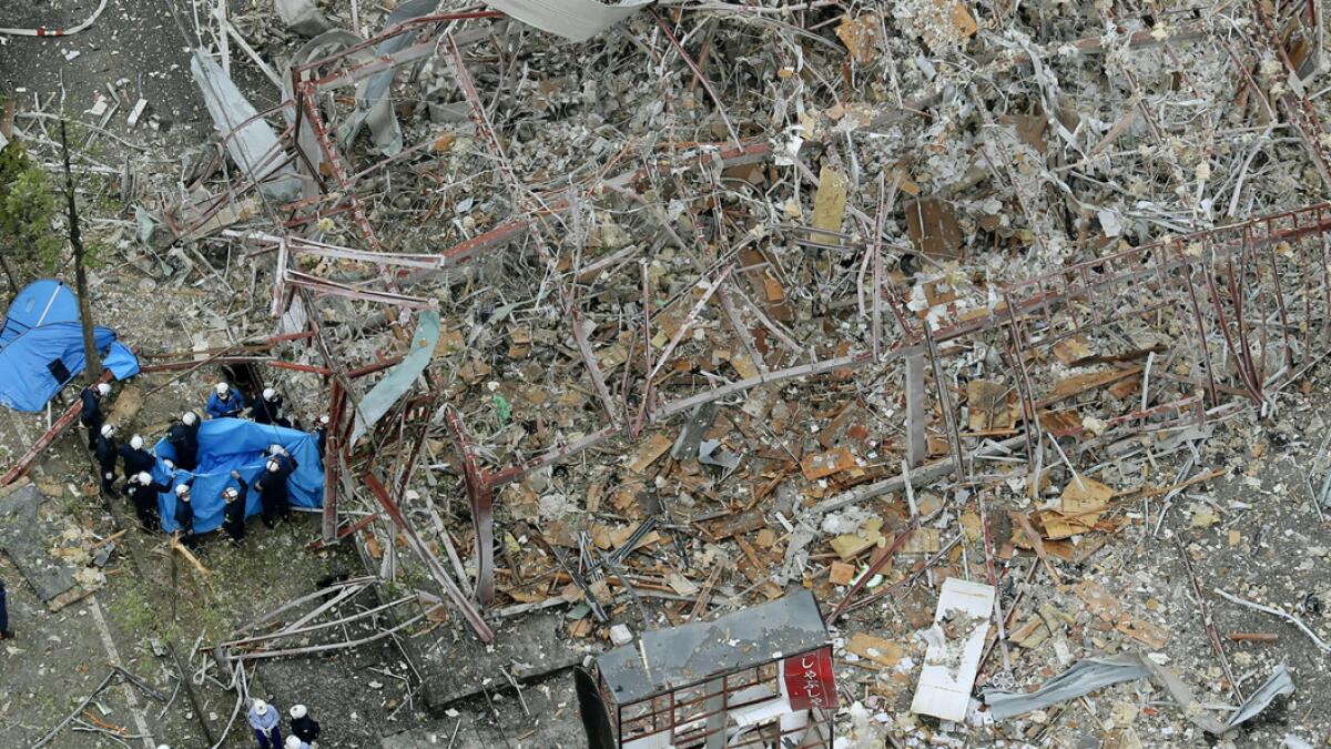 Investigators work at the site of an explosion in Koriyama, Fukushima prefecture, northern Japan. At least more than a dozen people were injured and being taken to hospitals after a sudden explosion blew off walls, windows and debris in the neighborhood. Photo: AP