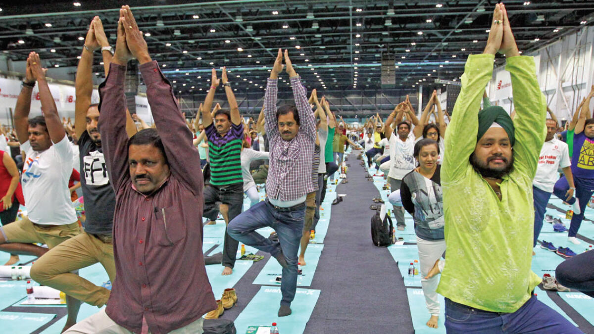 Thousands of residents who turned up at the world trade Centre to mark international yoga Day exercised as one as they emulated the different yoga poses at the event. — Photos by Rahul Gajjar