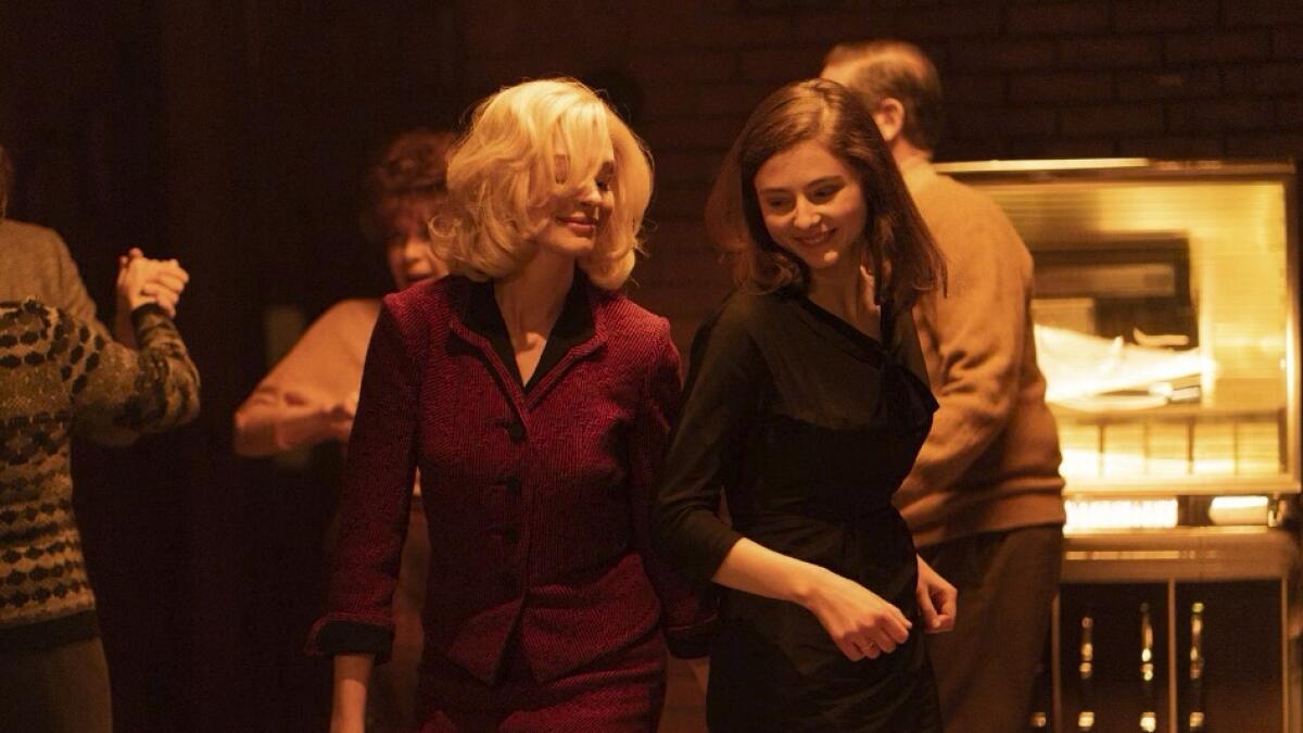 Anne Hathaway, left, and Thomasin McKenzie in a scene from 'Eileen'