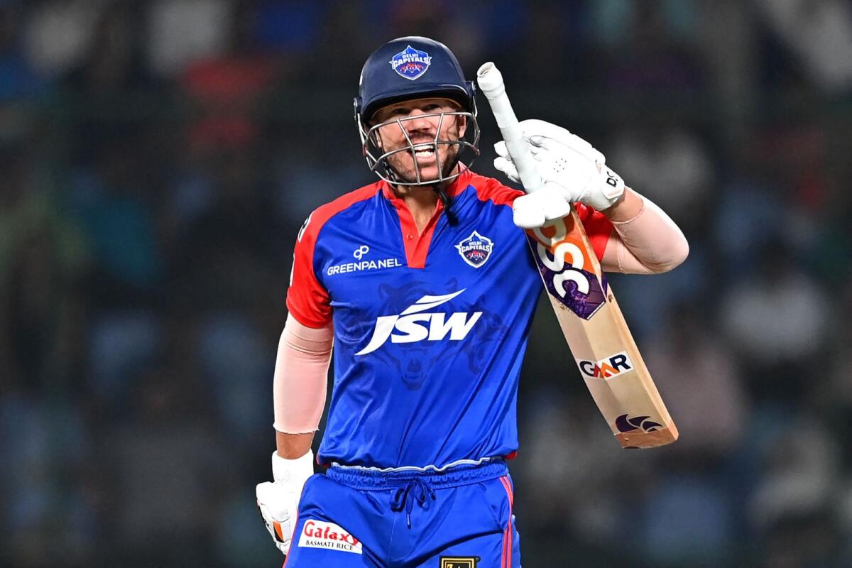 Delhi Capitals' David Warner reacts as he walks back to the pavilion after his dismissal during the IPL match against Mumbai Indians. — AFP