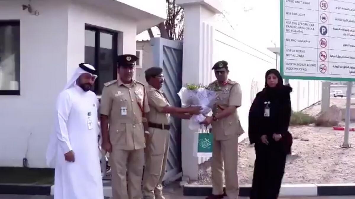 Dubai Police, honour, bouquet, smiling policeman, headquarters