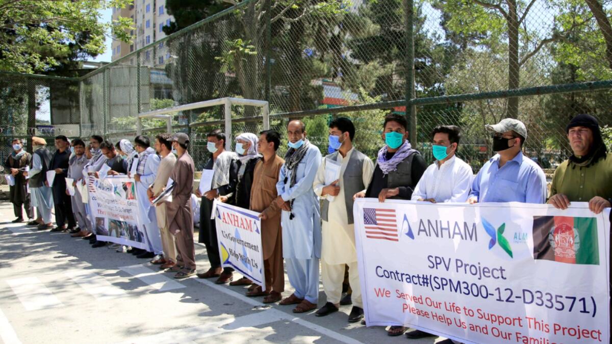 Former workers who had been employed with US troops at the Bagram airbase hold placards during a demonstration against the US government in Kabul. — AP file