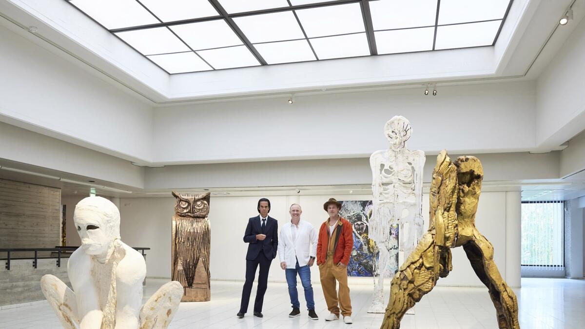 British artist Thomas Houseago, centre, poses with US actor Brad Pitt, centre right and Australian musician Nick Cave (Photo: AP)