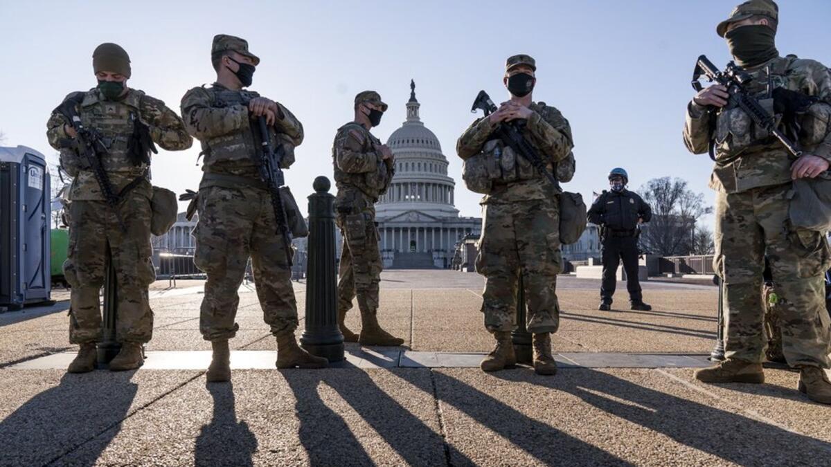 Members of the Michigan National Guard and the US Capitol Police keep watch near the US Capitol. — AP