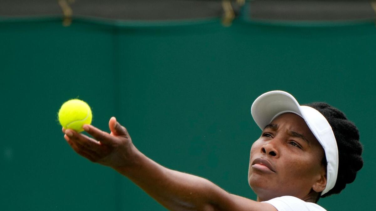Venus Williams of the US serves to Romania's Mihaela Buzarnescu during the women's singles first round match. (AP)