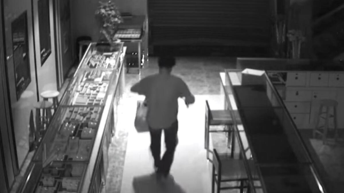 Video: Robber squeezes in through shutter, steals Dh194,000
