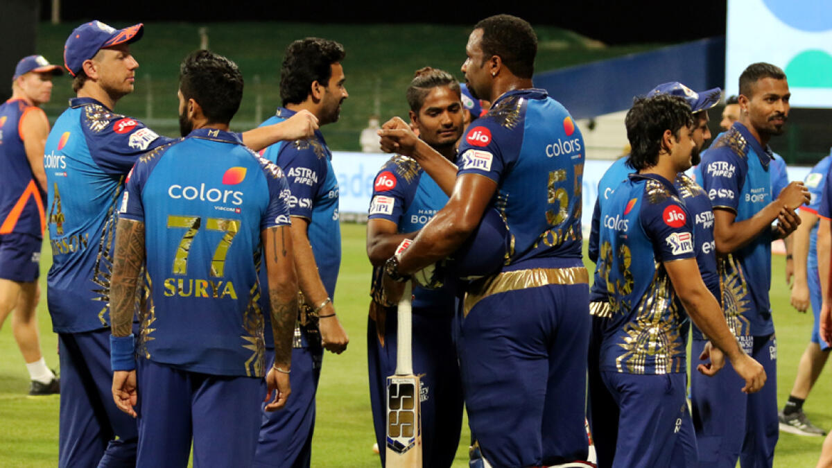 Mumbai Indians' players celebrate their win against Delhi Capitals during the Indian Premier League match at the Sheikh Zayed Stadium. - IPL
