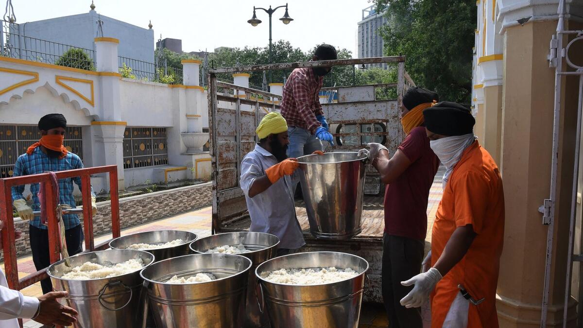 Volunteers upload prepared food at a gurudwara in New Delhi. Photo: AFP