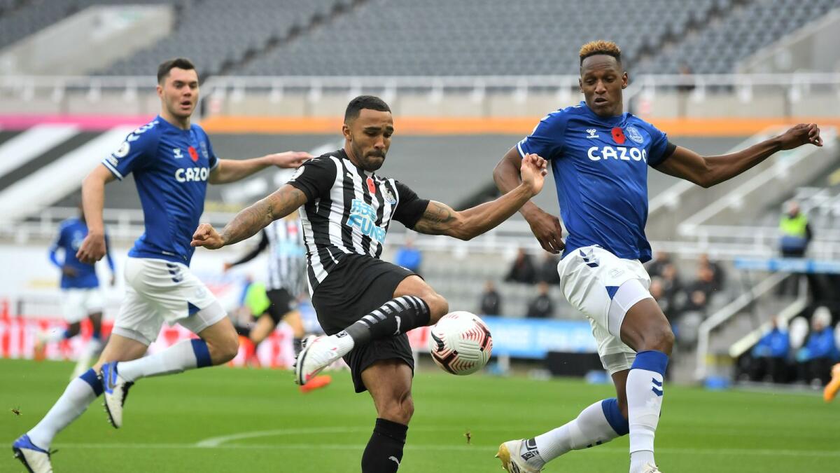 Newcastle United's Callum Wilson (centre) vies for the ball with Everton's Yerry Mina during the English Premier League match. — AFP