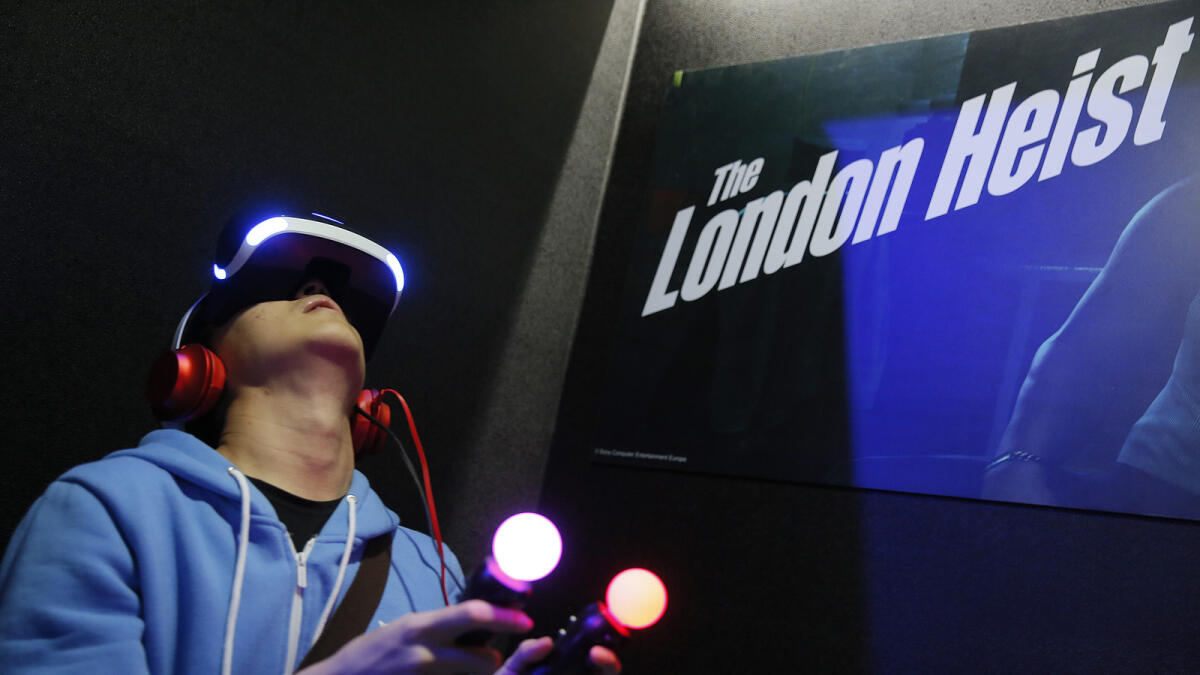 A video game enthusiast experiences the Playstation VR virtual reality headset with the game The London Heist at the Taipei Game Show 2016 in Taipei.