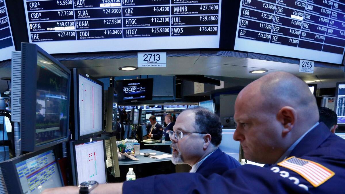 Getco Securities Specialist traders Michael O'Connor and Douglas Johnson work at a post on the floor at the New York Stock Exchange. -- Reuters file photo