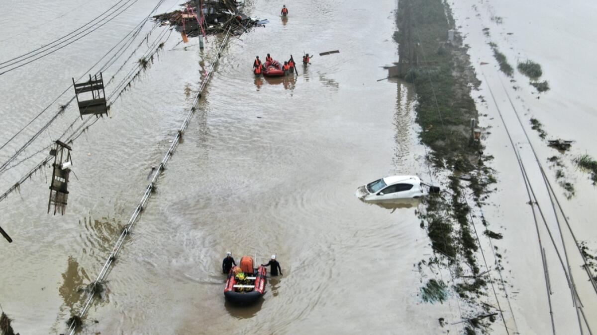 This aerial drone photo shows residents are rescued by boat following a heavy rain in Kumamura, Kumamoto prefecture, southern Japan  Sunday, July 5, 2020. Deep floodwaters and the risk of more mudslides hampered search and rescue operations on Sunday in southern Japan, including at elderly home facilities where more than a dozen perished and scores are still stranded. AP