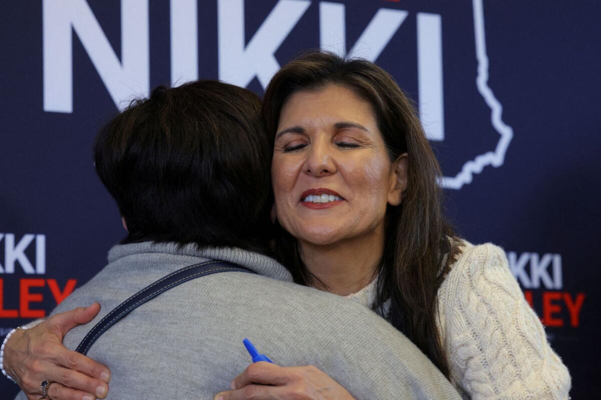 Republican presidential candidate and former US ambassador to the United Nations Nikki Haley hugs an audience member at a Get Out the Vote campaign rally ahead of the New Hampshire primary election in Derry, New Hampshire, US, on January 21, 2024.   — Reuters