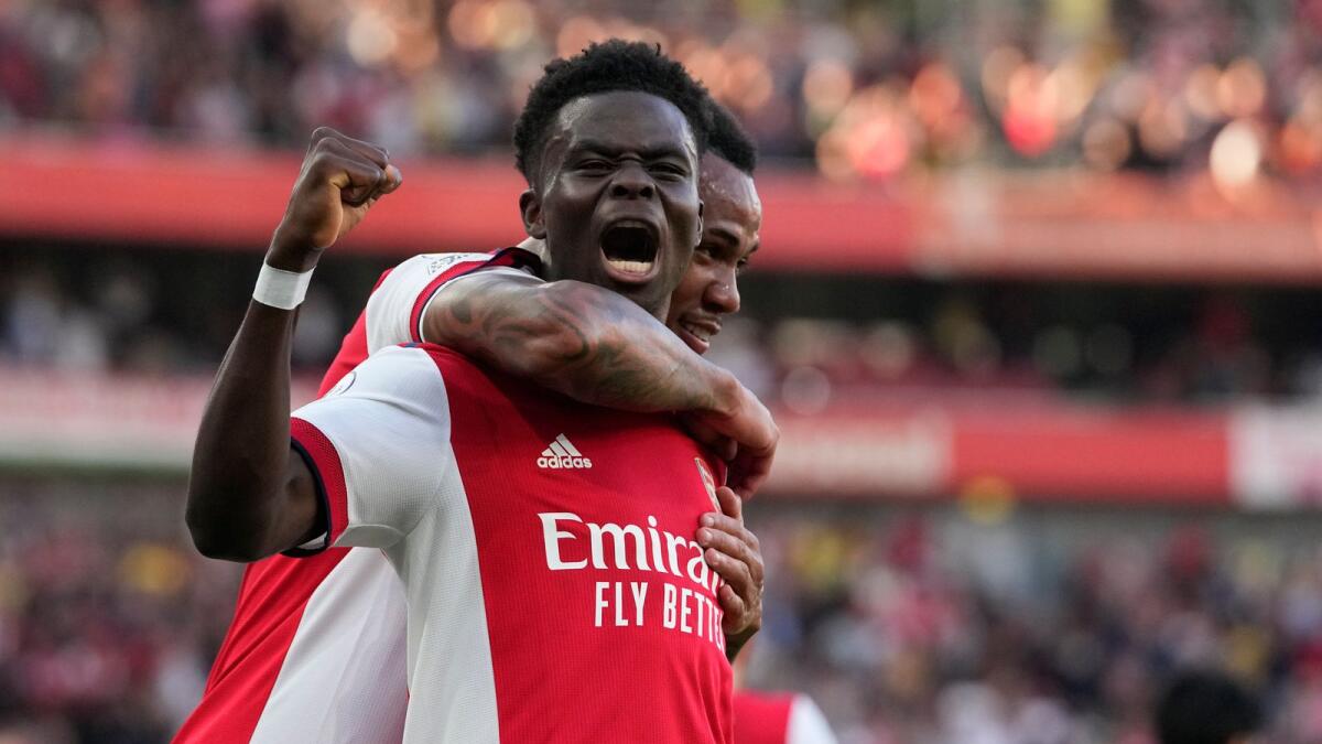 Arsenal’s Bukayo Saka celebrates after scoring his side’s third goal. — AP