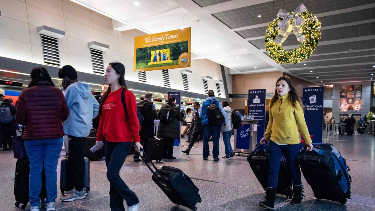 Travellers make their way through the terminal at Logan International Airport in Boston, Massachusetts, on Friday.— AFP