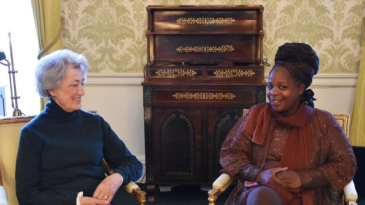 Lady Susan Hussey with Ngozi Fulani, founder of the charity Sistah Space in the Regency room in Buckingham Palace, London. –Reuters