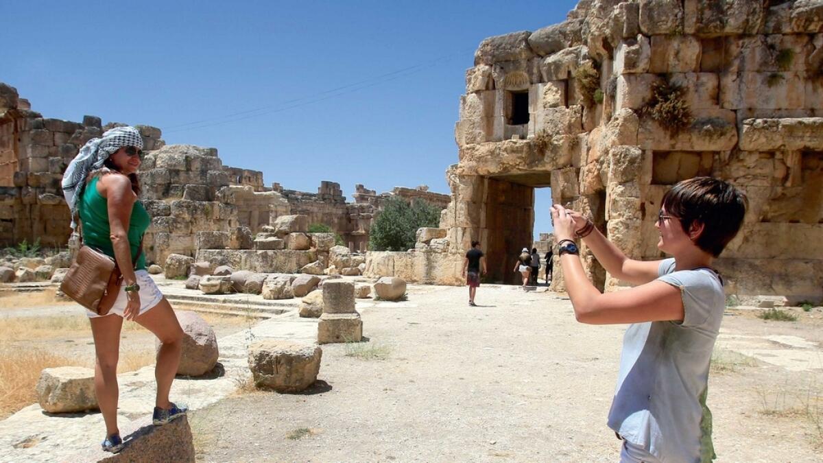 The Lebanese government is taking steps to improve stability and boost the economy. Here, tourists take pictures during their visit to the Roman ruins of the Baalbek Temples in eastern Lebanon. —Reuters
