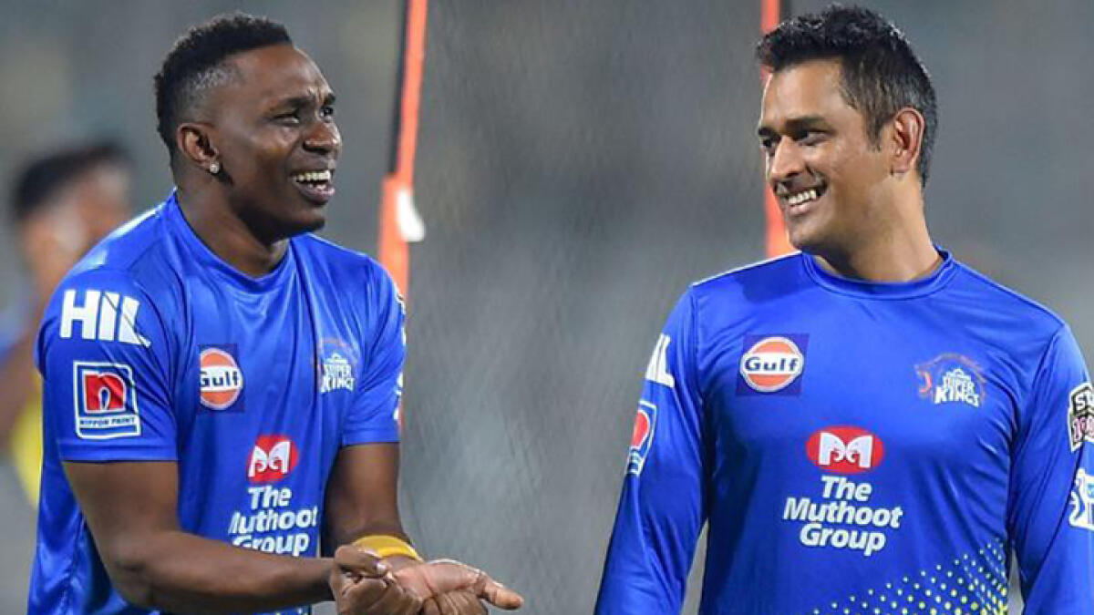 MS Dhoni and Dwayne Bravo, teammates for Chennai Super Kings, share a light moment during a training session. -- File photo