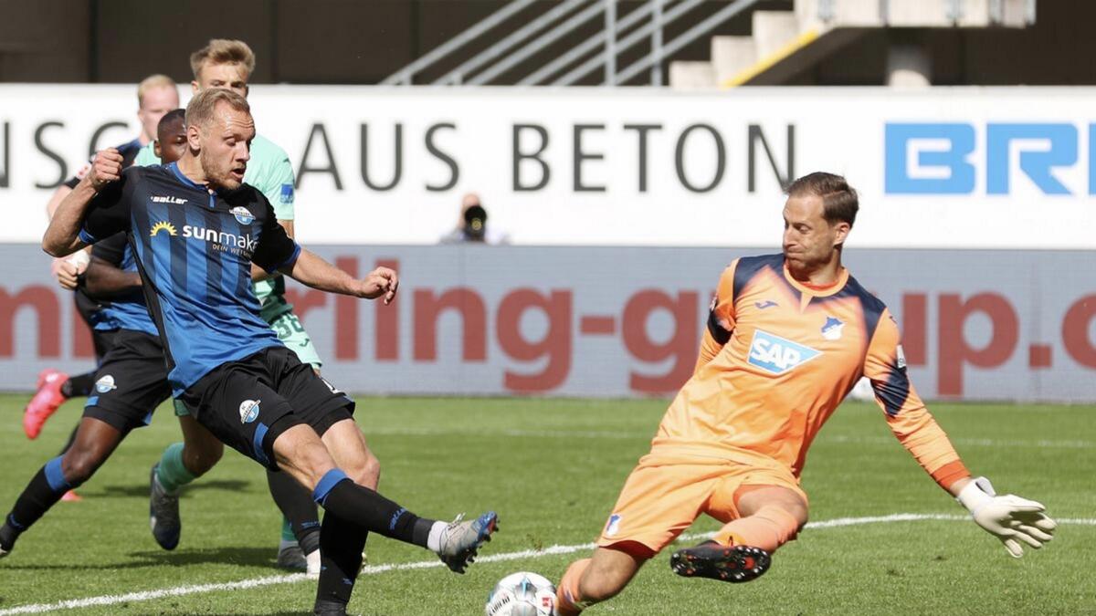 Hoffenheim's Oliver Baumann in action with Paderborn's Ben Zolinski in the Bundesliga on Saturday. - Reuters