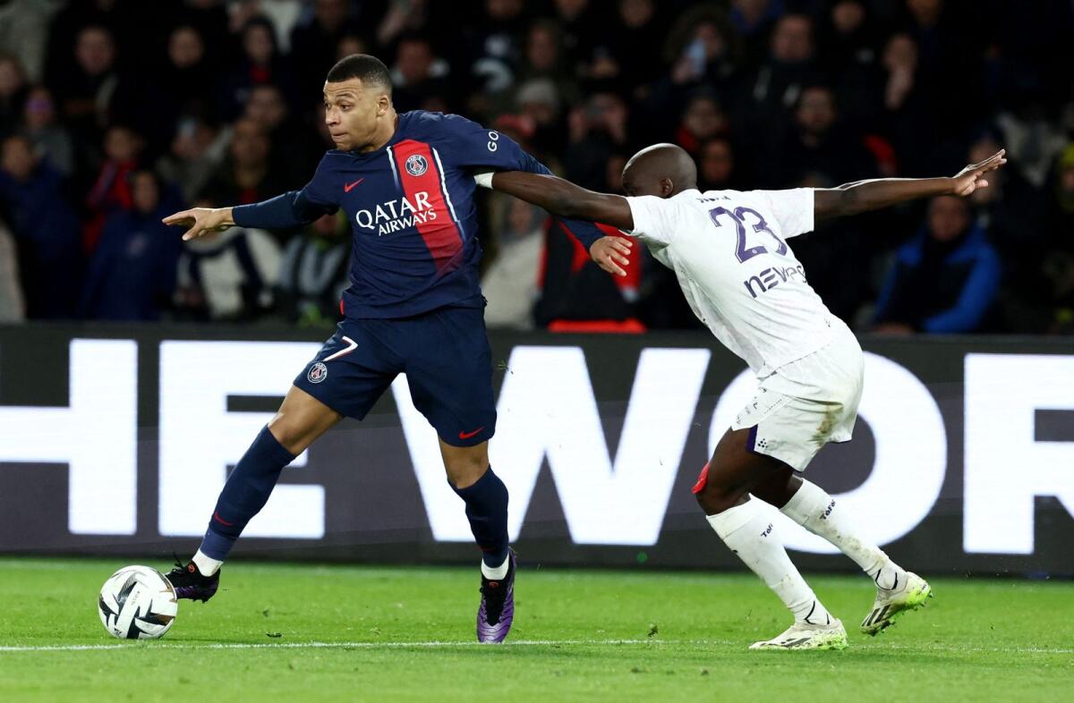 Paris St Germain's Kylian Mbappe in action with Toulouse's Moussa Diarra. - Reuters