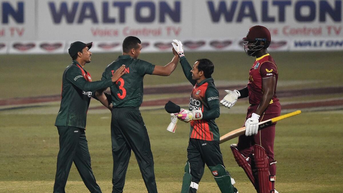 Bangladesh's players celebrate the dismissal of West Indies' Raymon Reifer. — AFP