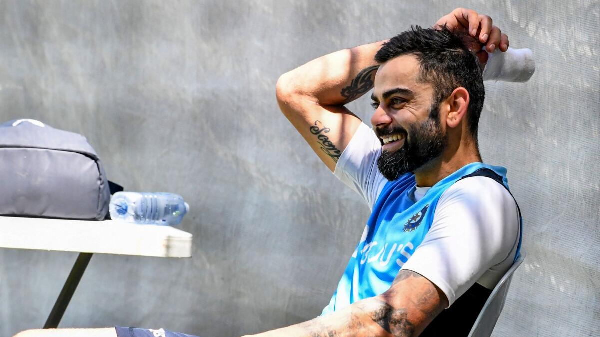 India's captain Virat Kohli smiles as he takes rest during a training session in Adelaide on December 15, 2020, ahead of the first Test cricket match between Australia and India. (Photo by Brenton EDWARDS / AFP)
