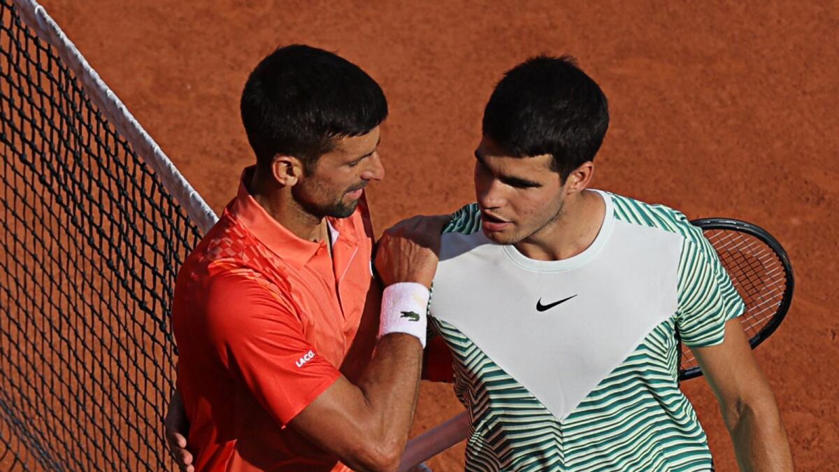 Serbia's Novak Djokovic comforts Spain's Carlos Alcaraz Garfia after his victory in their men's singles semifinal at Roland-Garros on June 9. - AFP