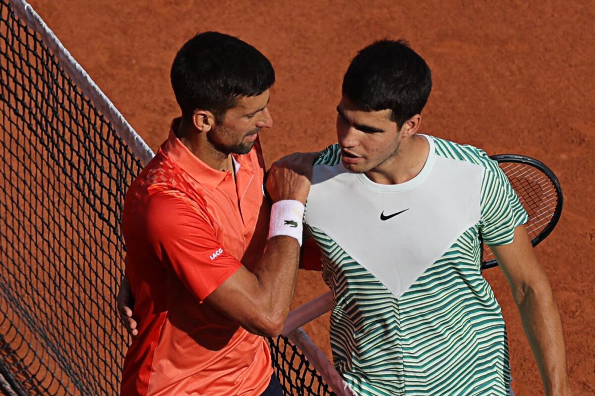Serbia's Novak Djokovic (left) comforts Spain's Carlos Alcaraz after his victory. — AFP