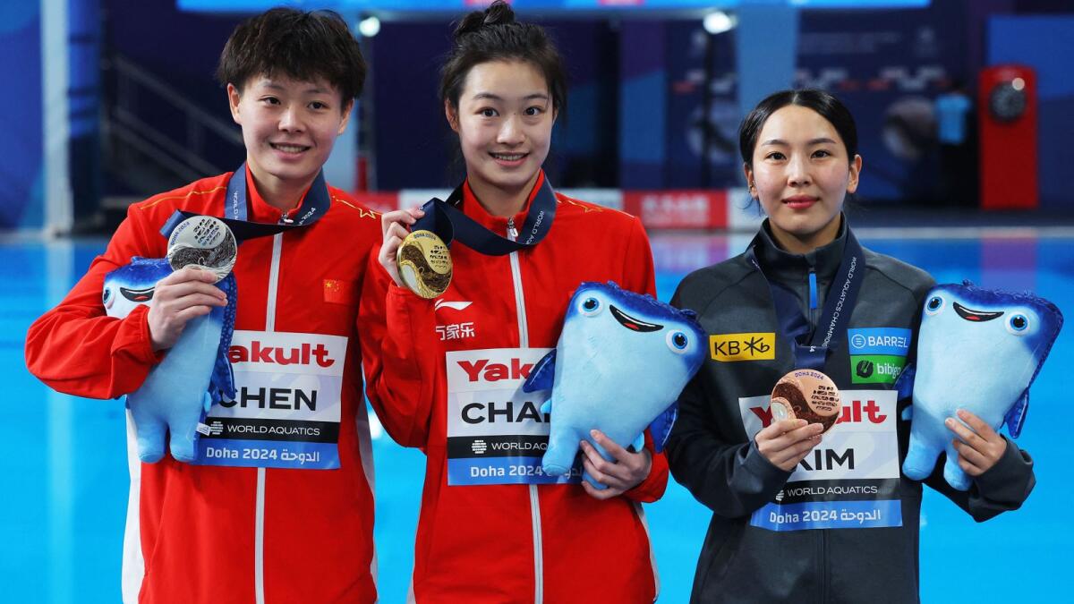 Gold medallist China's Yani Chang celebrates winning the women's 3m springboard final alongside silver medallist China's Yiwen Chen and bronze medallist South Korea’s Suji Kim. - Reuters