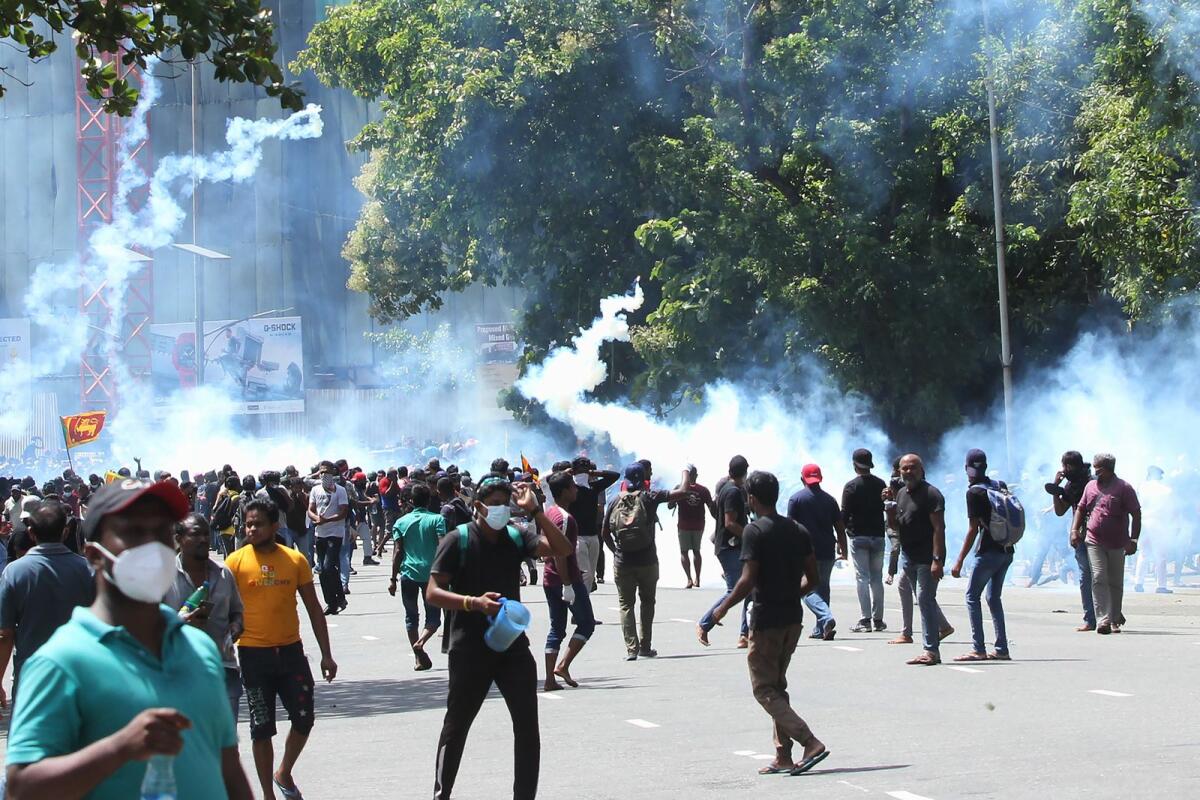 Police use tear gas to dispers protestors demanding the resignation of Sri Lanka's President Gotabaya Rajapaksa in Colombo on July 9, 2022 (Photo by AFP)