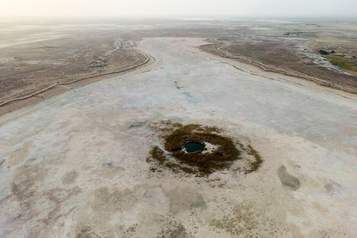 A dried Sawa Lake is surrounded by a dry bed in Iraq on April 10, 2023. — AP