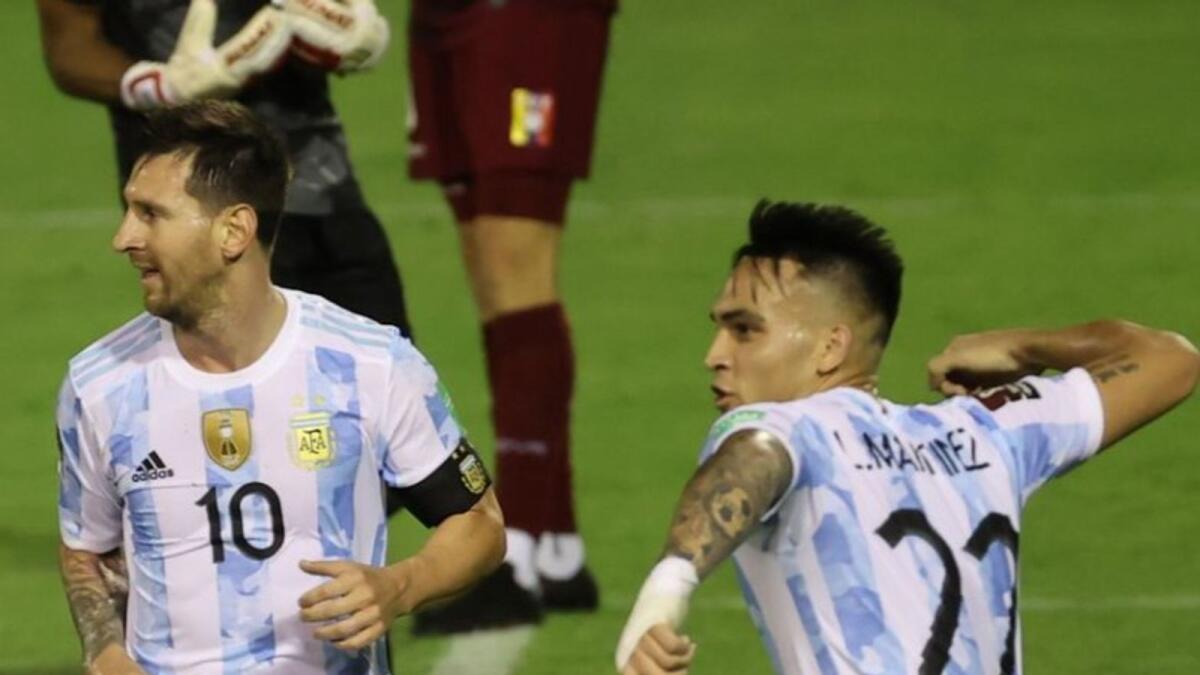 Argentina's Lautaro Martinez celebrates after scoring their first goal with Lionel Messi. (Reuters)