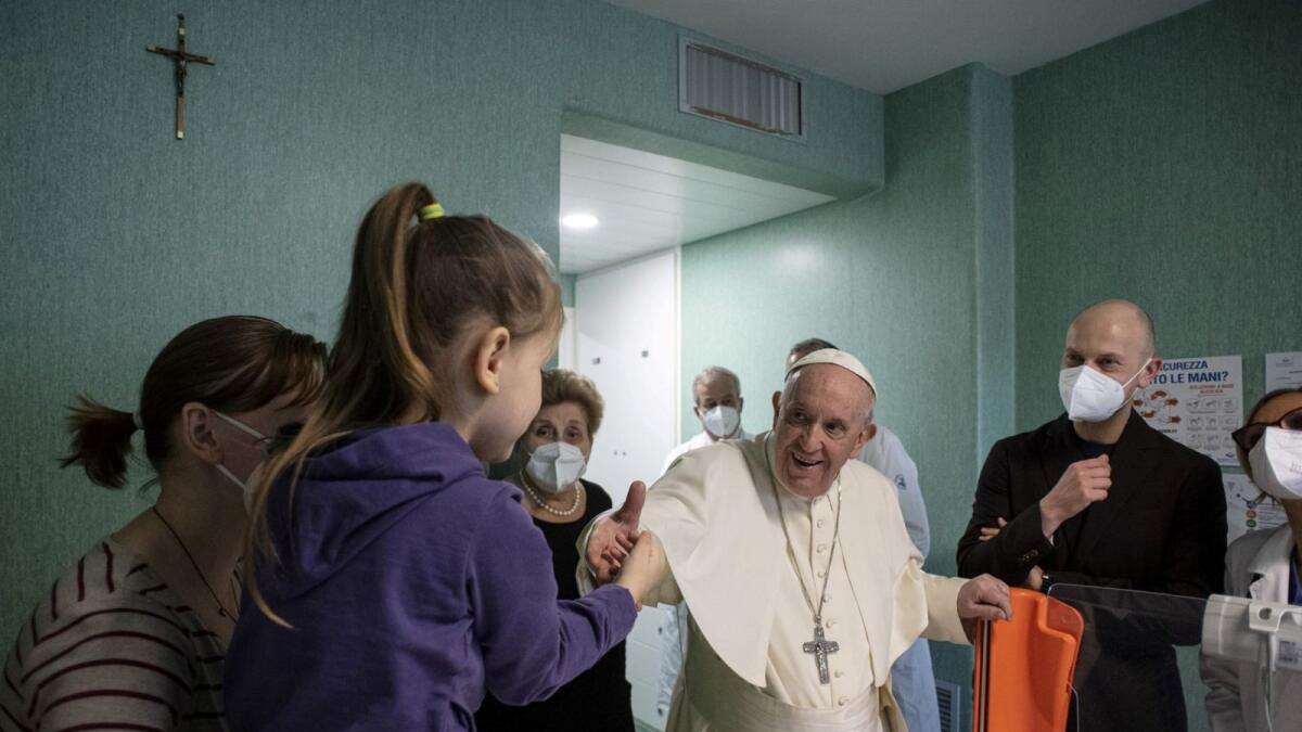 Pope Francis meets a girl during a visit to the Bambino Gesu Children's Hospital in Rome, in the ward where the children who arrived from Ukraine in the last few days are being treated. – AFP