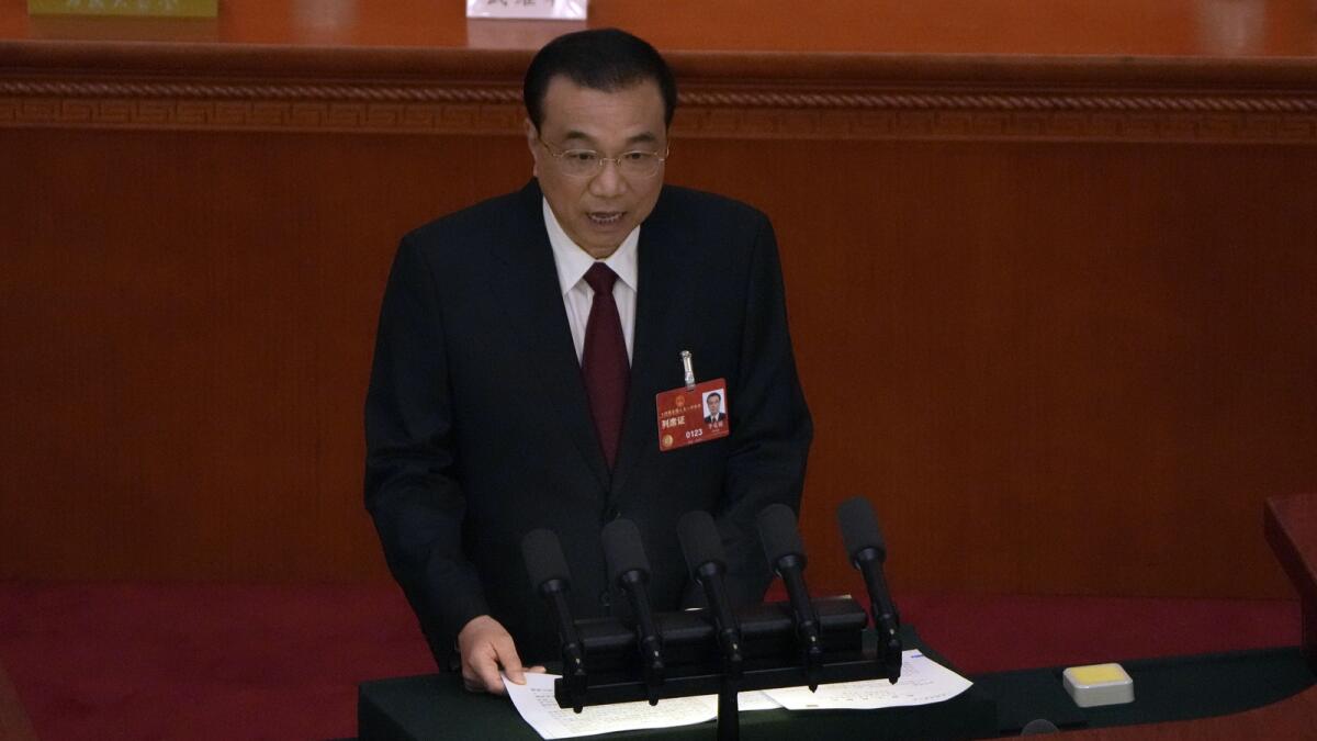 Chinese Premier Li Keqiang speaks during the opening session of China's National People's Congress (NPC) at the Great Hall of the People in Beijing on Sunday. - AP