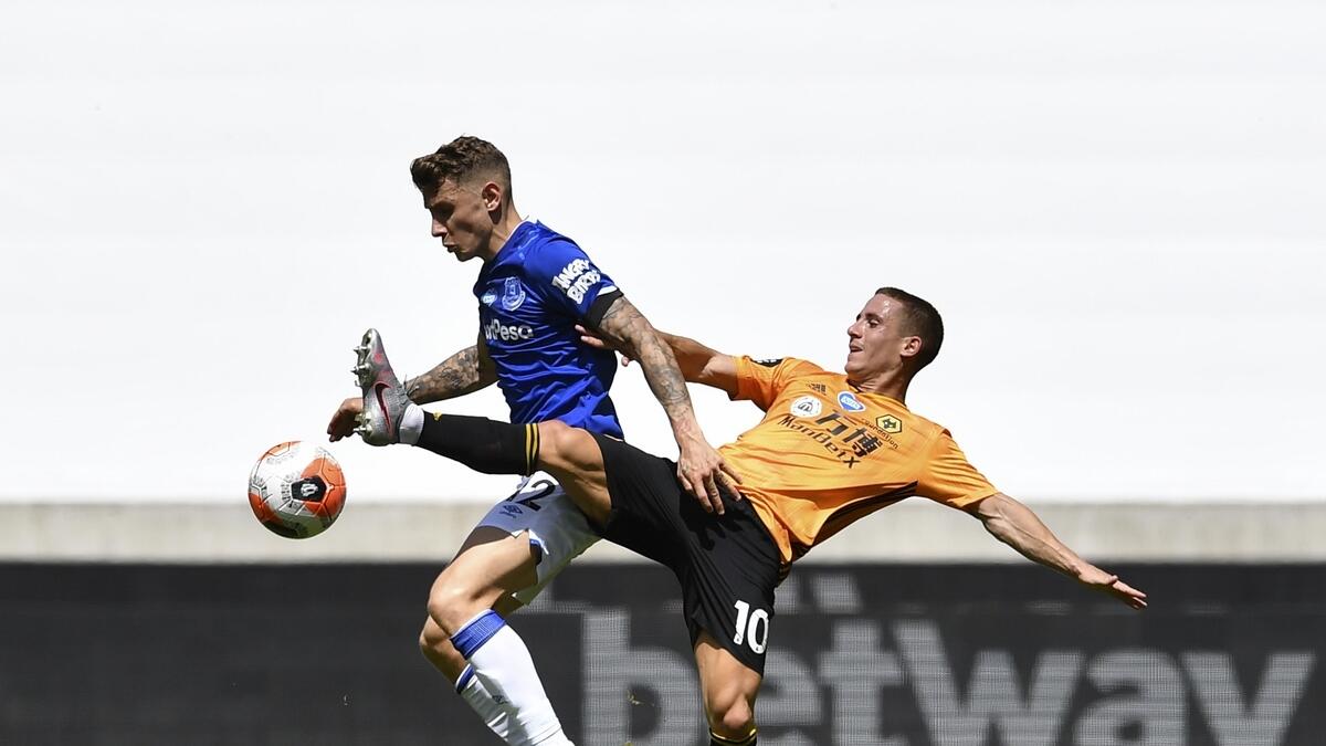 Everton's Lucas Digne (left) duels for the ball with Wolverhampton Wanderers' Daniel Podence during the English Premier League soccer match at the Molineux Stadium in Wolverhampton, England on Sunday. - AP