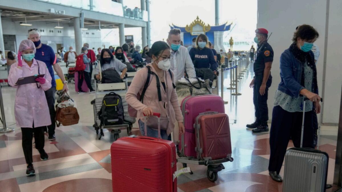 Tourists leave after arrival at Suvarnabhumi International Airport in Bangkok, Thailand. — AP