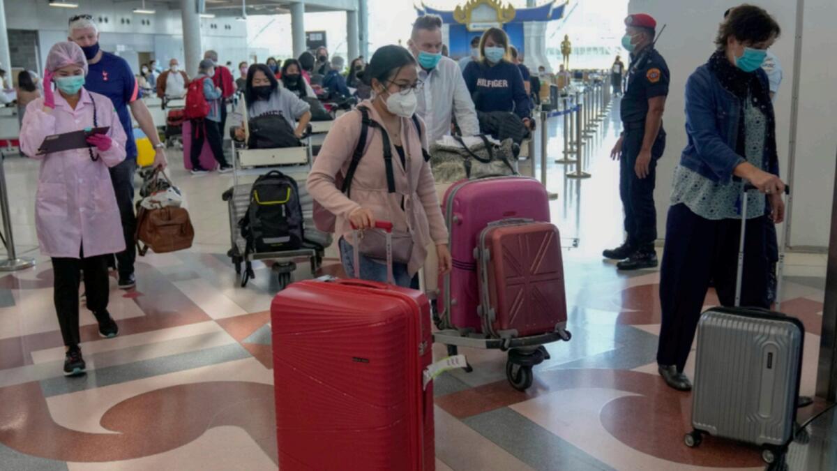 Tourists leave after arrival at Suvarnabhumi International Airport in Bangkok, Thailand. — AP