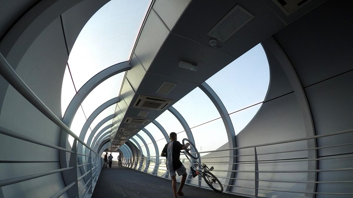 Just like the road... A cyclist passes through the pedestrian bridge near Al Qusais Police Station. Most of the bridges have ramps and elevators that would help commuters.