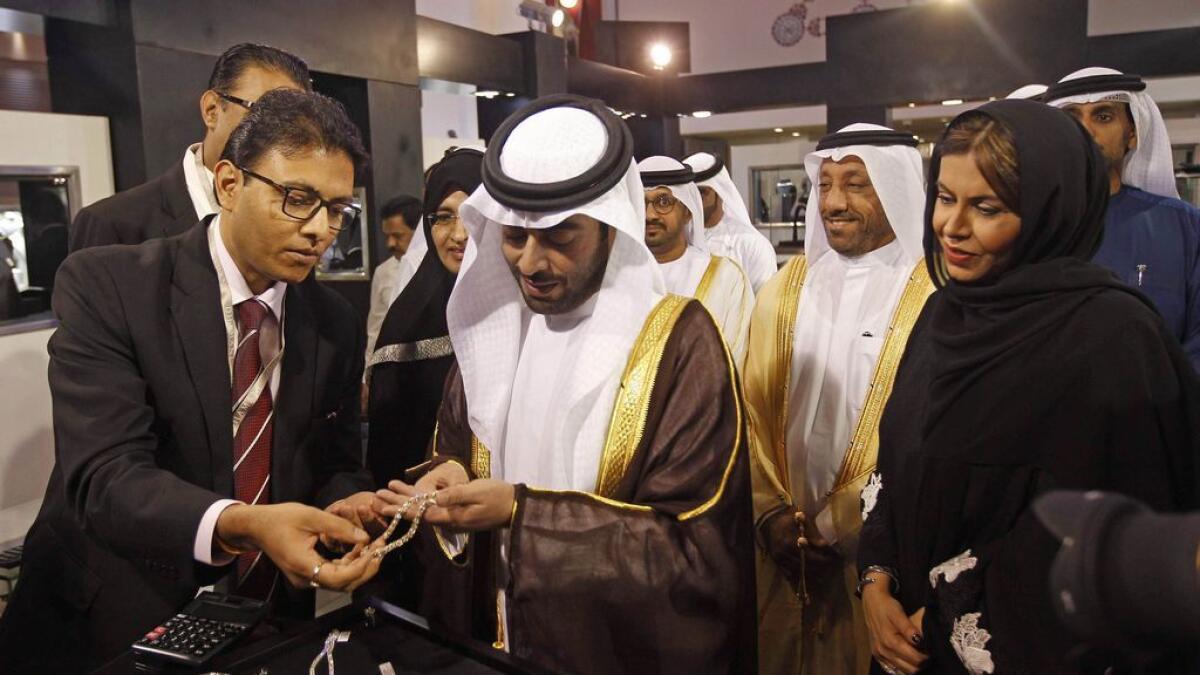 Shaikh Khalid bin Abdullah bin Sultan Al Qasimi tours the 40th edition of the MidEast Watch and Jewellery Show at Expo Centre Sharjah on Tuesday; and below exhibitors display their products at the show. 