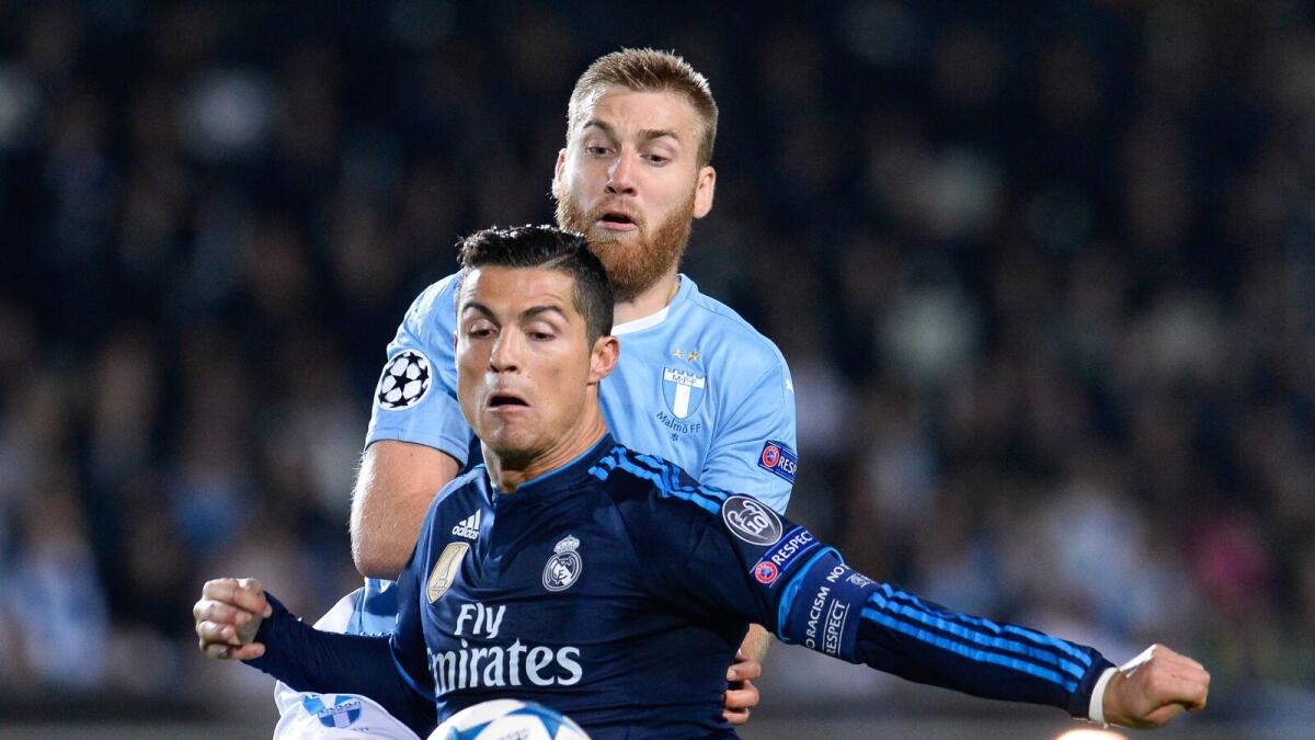 Real Madrid’s Cristiano Ronaldo (front) and Malmo’s Jo Inge Berget vie for the ball during the UEFA Champions League match.