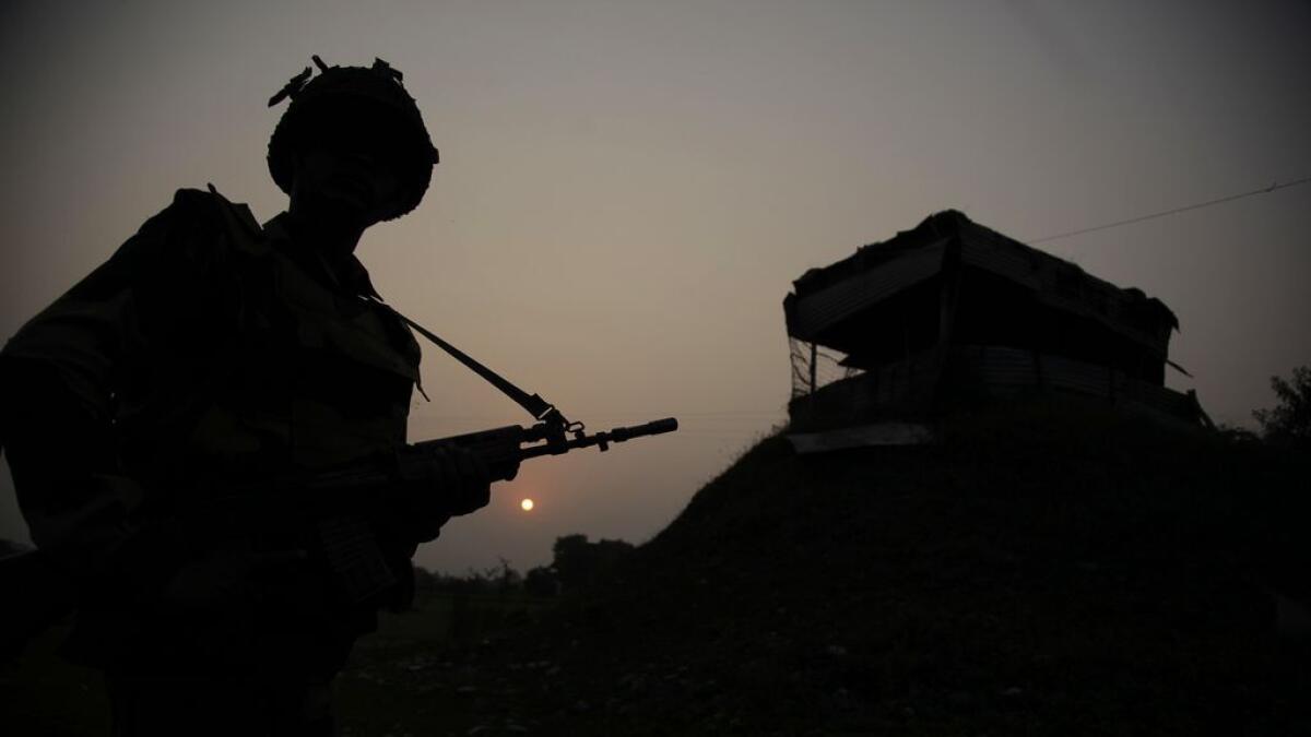 Indian Border Security Force soldiers patrol near the India-Pakistan international border