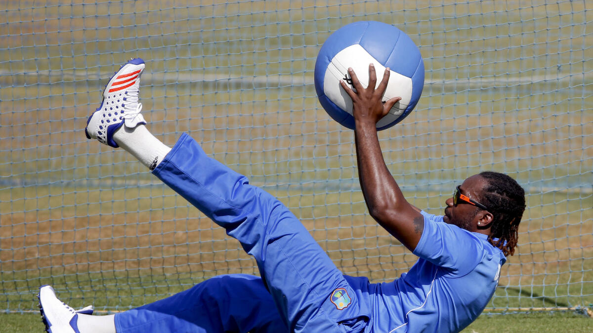 Chris Gayle warms up during a practice session ahead of their match against England in Mumbai.  